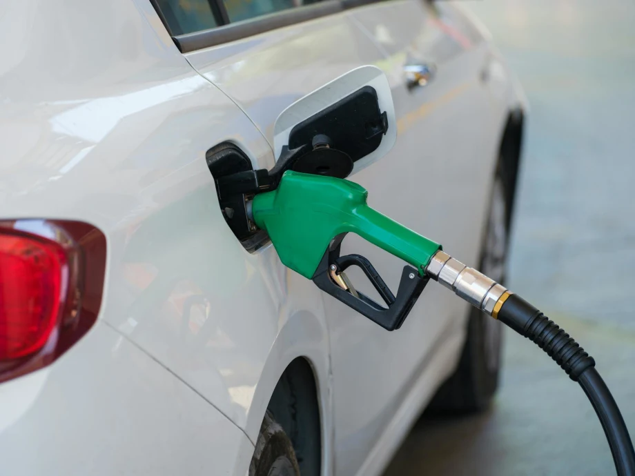 A while diesel car fueling with a green nozzle.