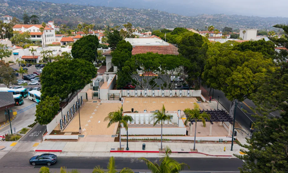 Overview of fast-charging depot in downtown Santa Barbara with panoramic view of coastal mountains and ocean in the background.