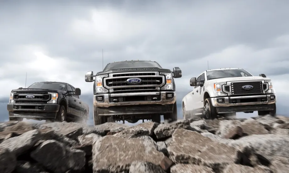 Various 2021-2022 Ford Super Duty driving on rocks towards the camera.