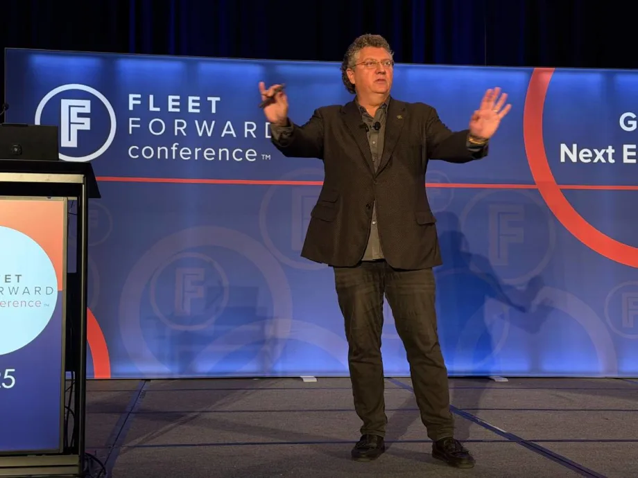 Speaker Bill Sims on the FFC stage with both hands up, emphasizing a point during his safety keynote address.