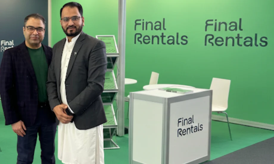 Final Rentals CEO Ammar Akhtar with Pakistani franchise owner Ahtsham Ali in front of a green-and-white car rental counter.