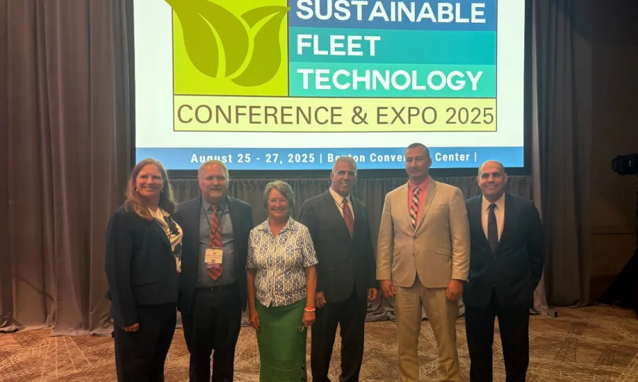 The Green Fleet Award Recipients pose in a line in front of a screen for this year's ceremony.