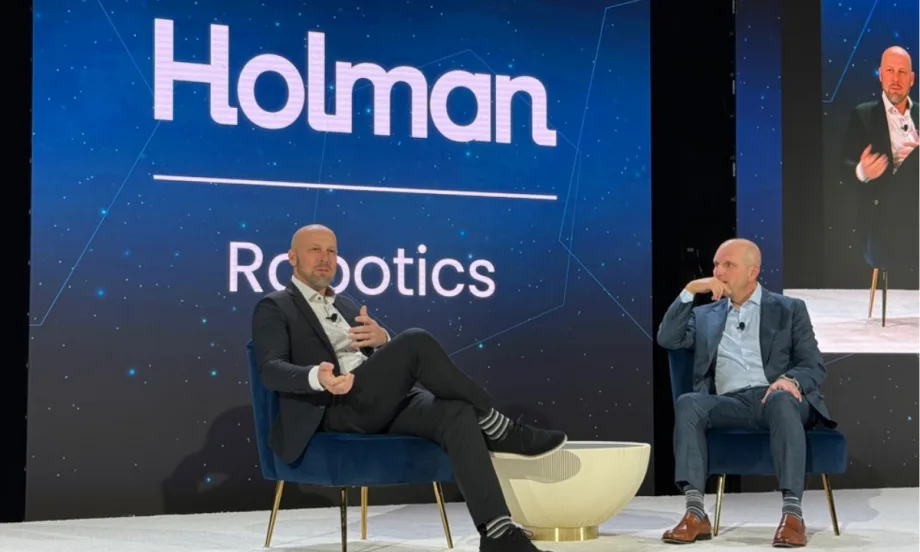 A photo of Homan CEO and vice president discussing the new robotics software at this year's conference.