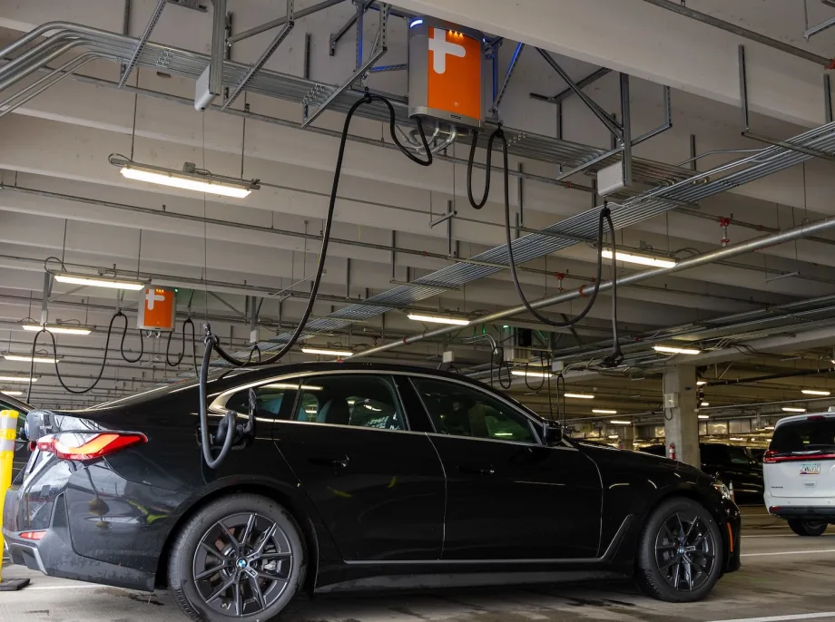 A black rental car is at a ChargePoint stations