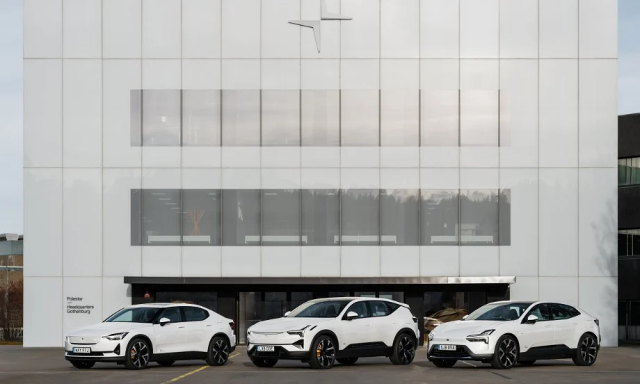 An image of three white Polestar cars lined up in front of a Polestar company building.