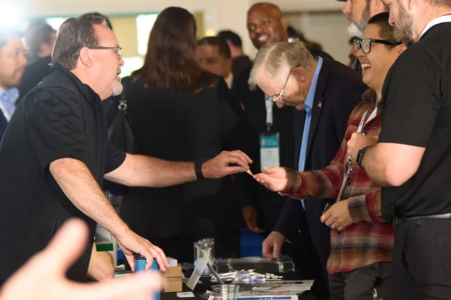 A group of people network at a Fleet Forward: the Tour event.