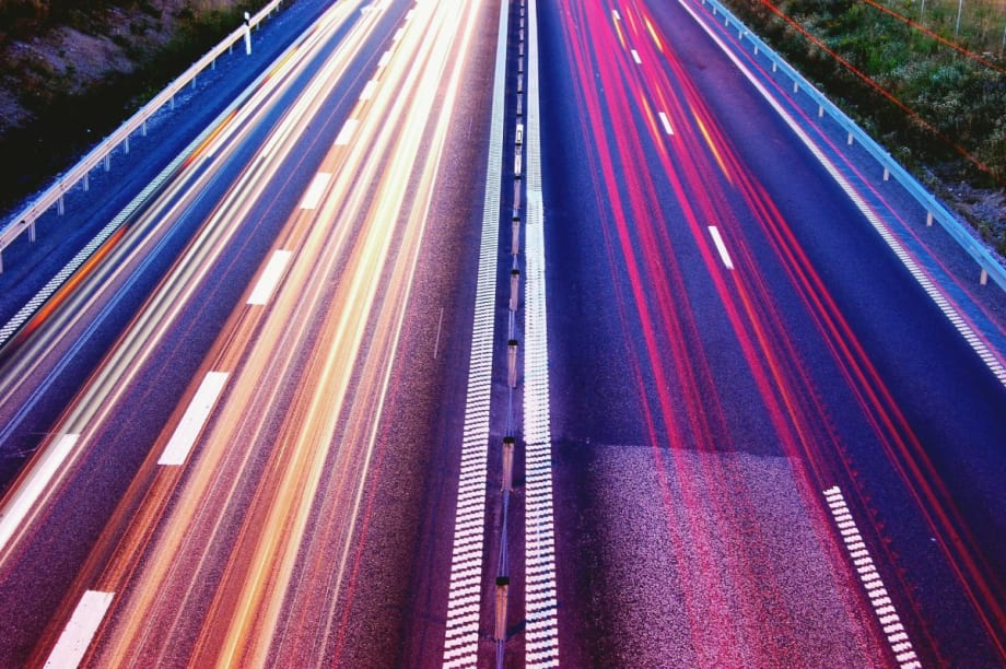 Rear view of a highway with multiple lanes of traffic.