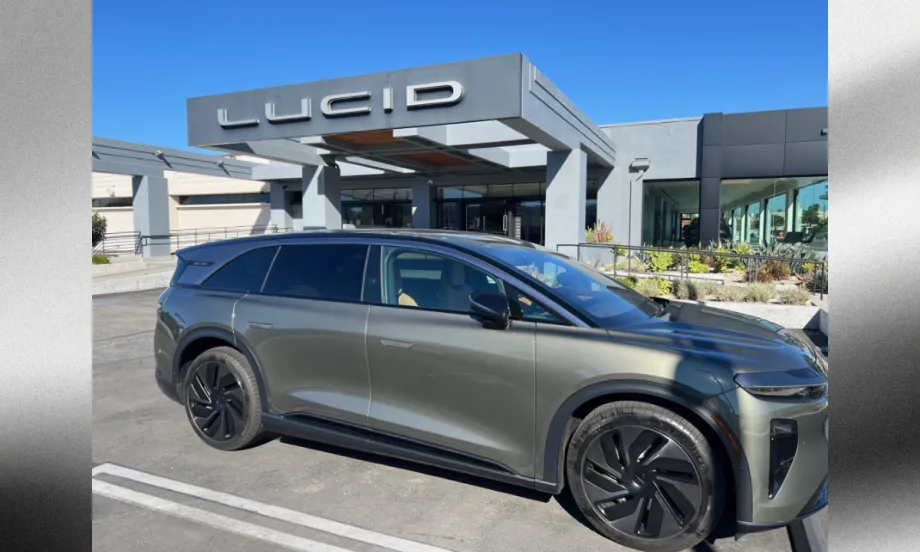 Lucid Gravity electric SUV parked outside a Lucid dealership, highlighting the company’s expanding EV lineup and plans for a new midsize platform and future mobility technologies.