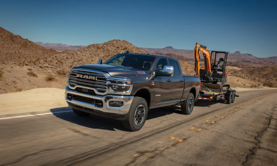 A Ram truck hauling construction equipment.