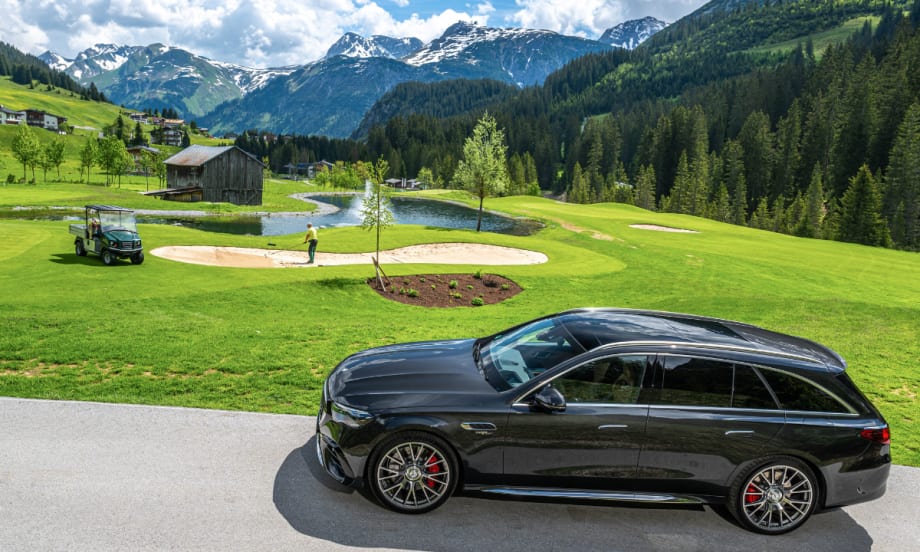 The European Mercedes Hybrid Wagon drives on a mountainside overlooking the landscape.
