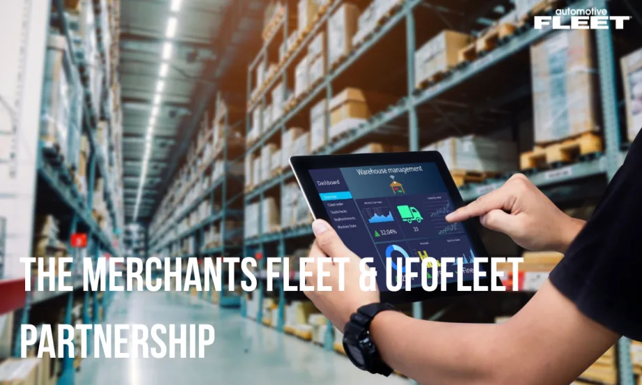 A fleet manager holds an iPad with displaying fleet information as he stands in a warehouse.