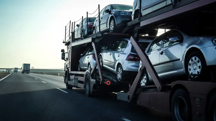 A double-decker stinger auto transporter loaded with new vehicles.