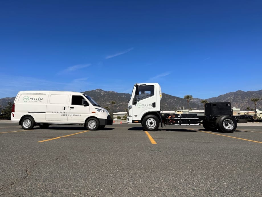 Two Mullen vehicles face each other in a parking lot.