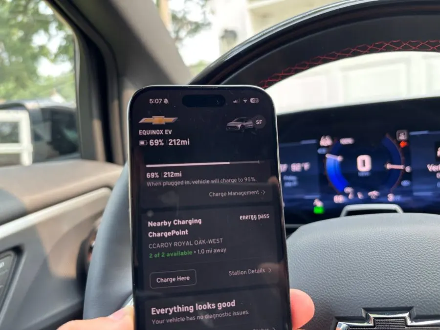 a hand holding a phone with the MyChevrolet Energy Pass chargin app open