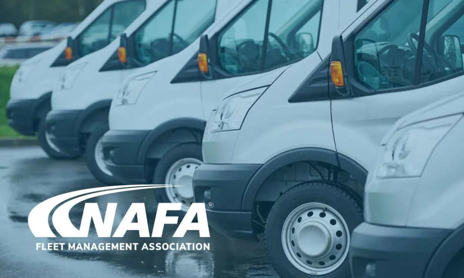 A fleet of white vehicles lined up in a parking lot.
