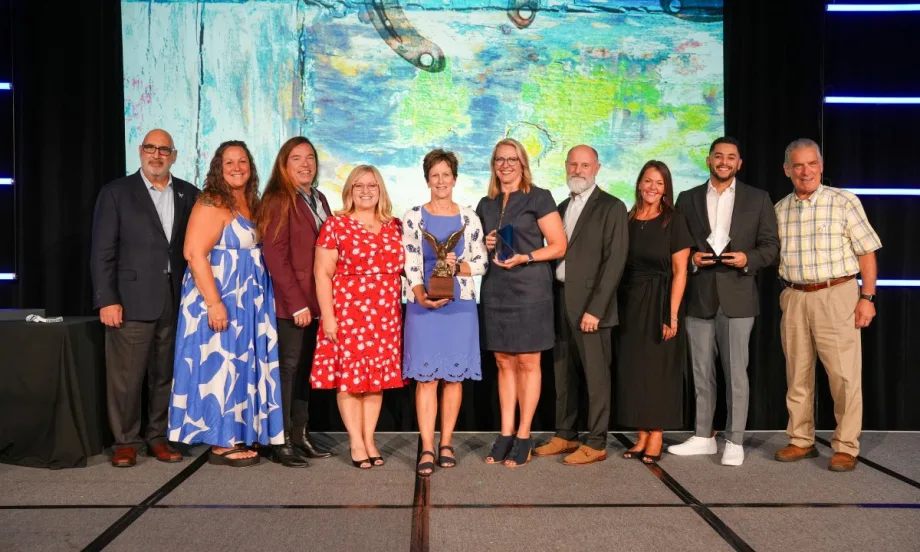 A group of past and present Fleet Managers of the Year and other award recipients pose on stage at the AFLA corporate fleet conference in San Antonio with the newest award winners.