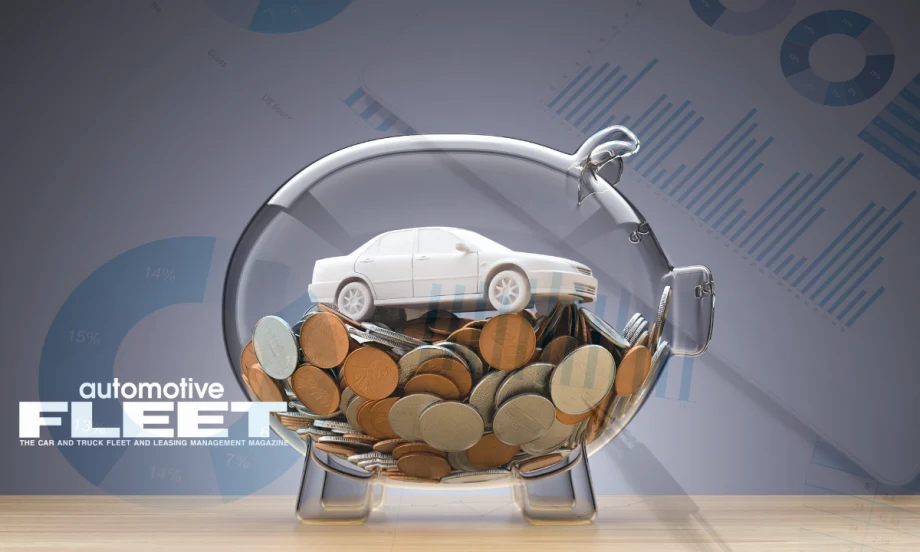 Photo of toy car in glass piggy bank.