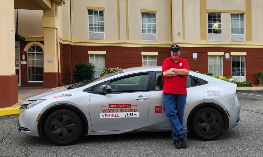 Wayne Gerdes poses in front of the Toyota Prius he drove across the country.