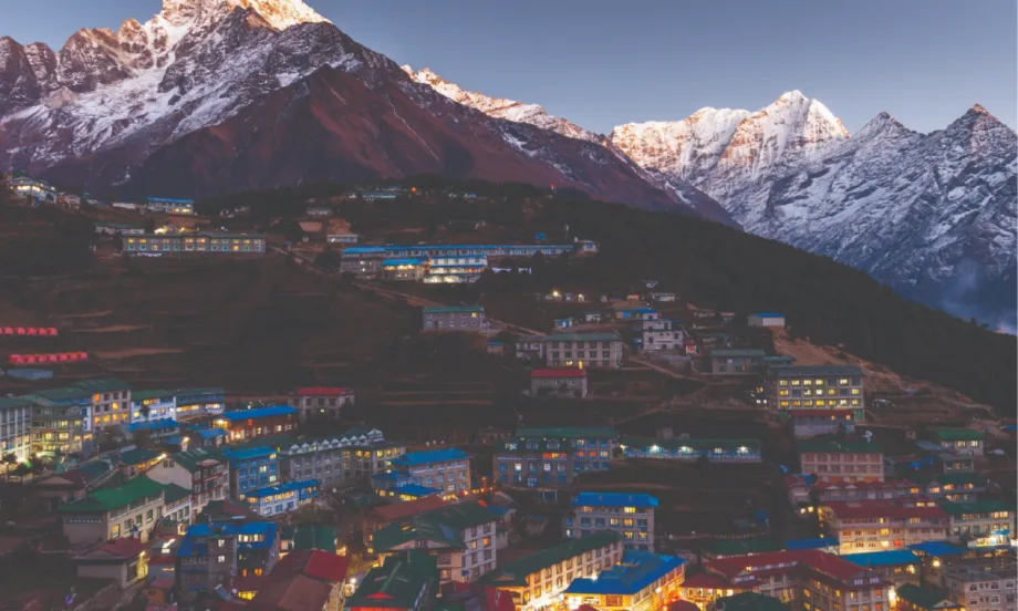 A photo of a Kathmandu region sloped against the foothills of the snow-capped Himalayas.