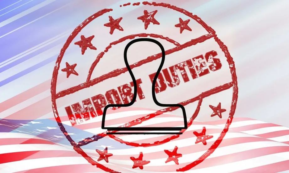An import duties stamp and stamper superimposed on a flat American flag.