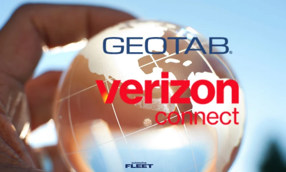 A hand holding a glass globe with the Geotab and Verizon Connect logos over them.