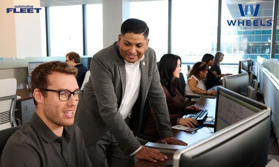 Hands typing on a laptop with AI graphics and rising data chart overlay, representing Wheels’ AI technology recognized with two 2026 AI Excellence Awards.
