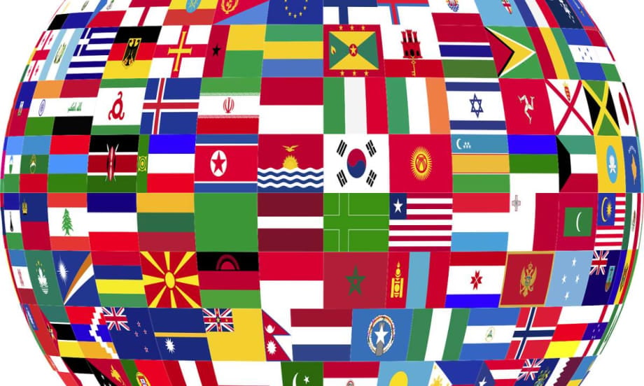 Close-up of the mid-section of a globe covered in flags of the nations.
