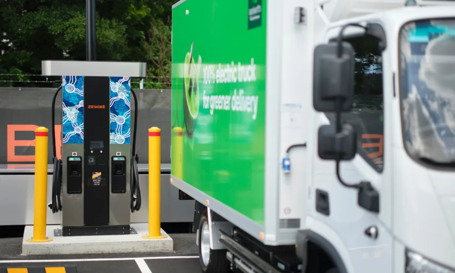Electric delivery truck charging at a Zenobē station in a commercial lot, highlighting fleet electrification and growth of zero-emission truck infrastructure in the U.S.
