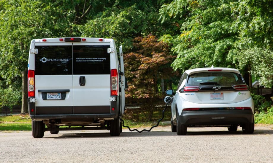 Two EVs charging from a mobile unit.